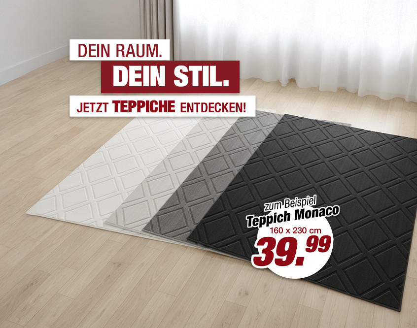 Raum mit hellem Holzboden und Teppich in vier Farbstreifen von Weiß bis Schwarz mit Rautenmuster.